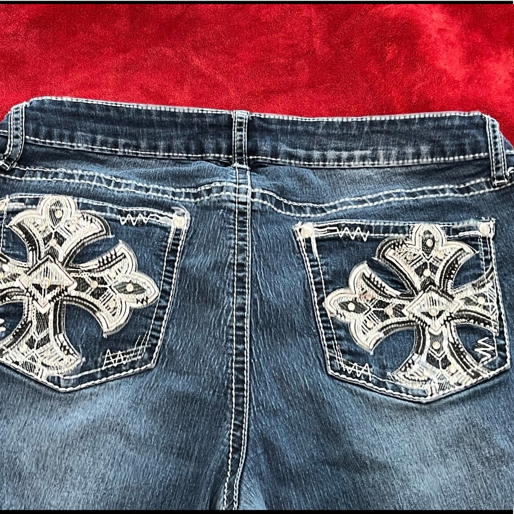 mid rise rhinestone jeans with cross design
